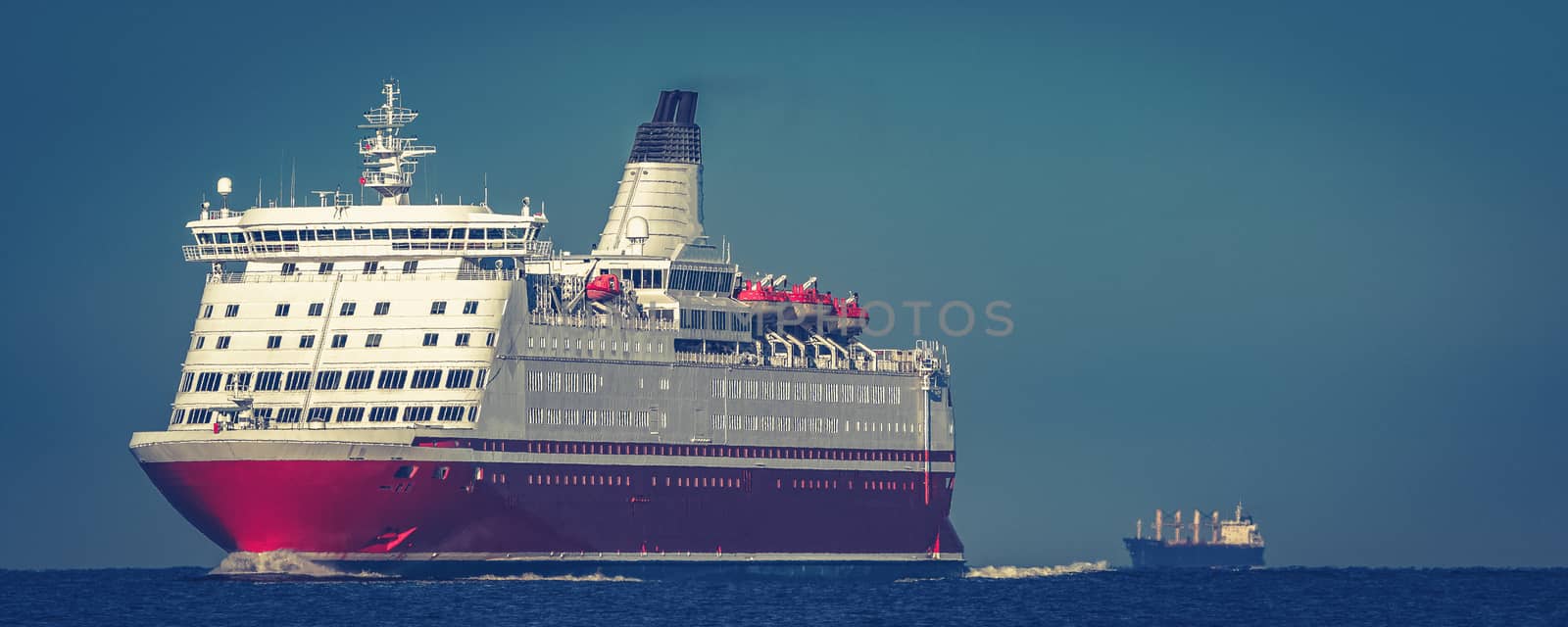 Red cruise liner. Large passenger ferry underway