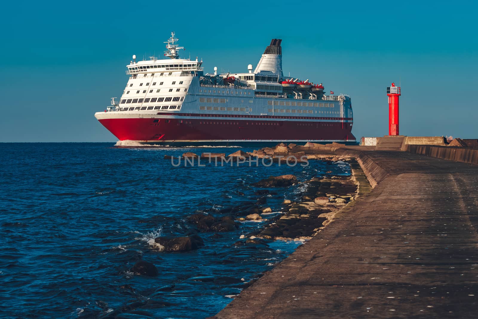 Red cruise liner. Large passenger ferry underway
