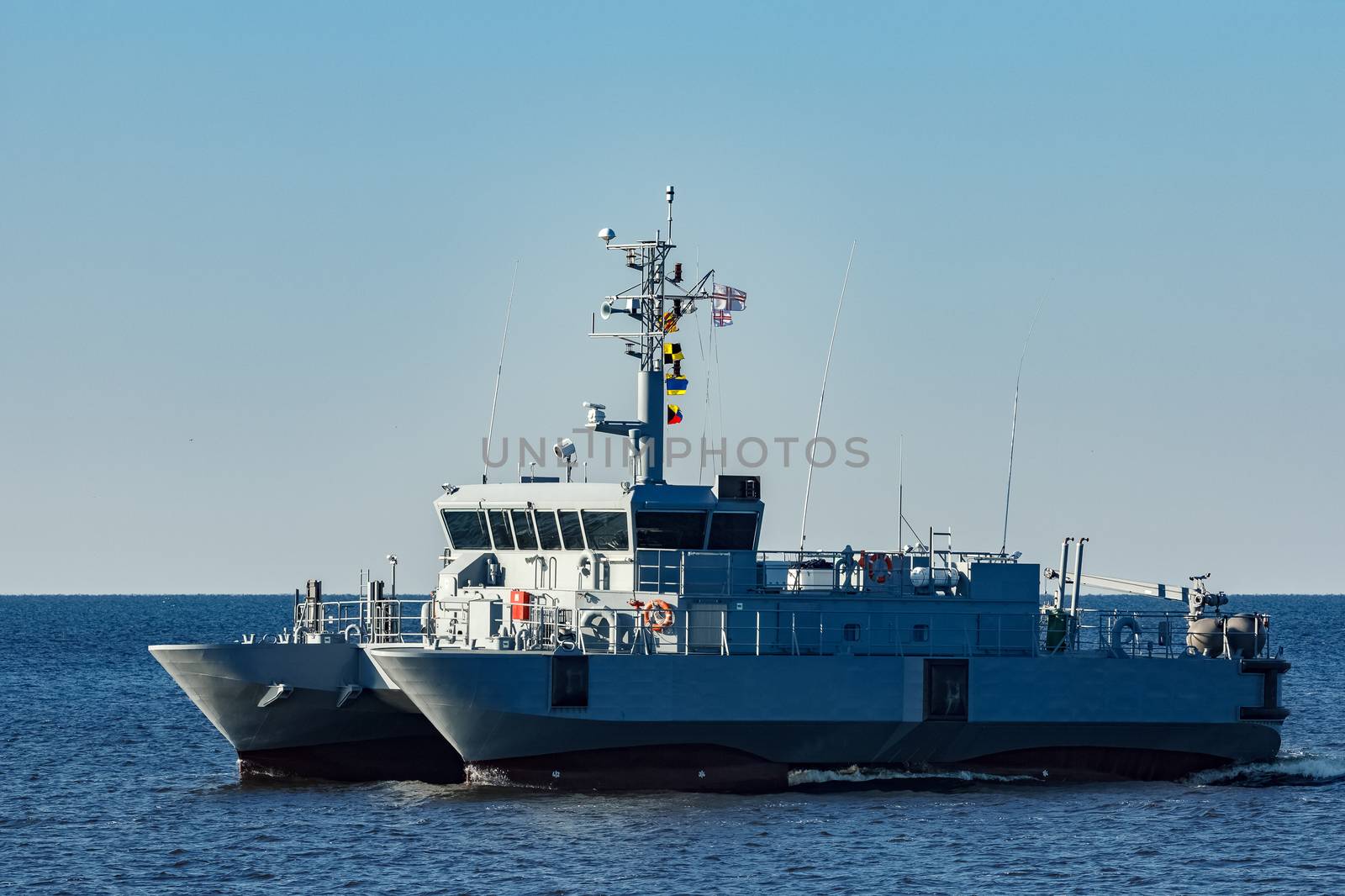 Small grey military ship moving from Baltic sea