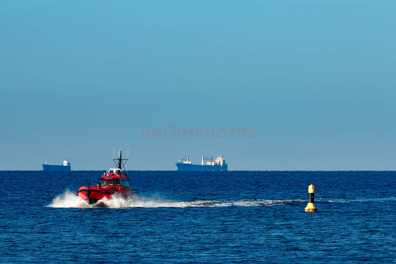 Red pilot ship moving from the Baltic sea