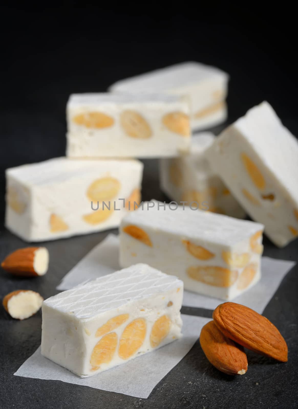 White nougat with almonds on black ardesia plate