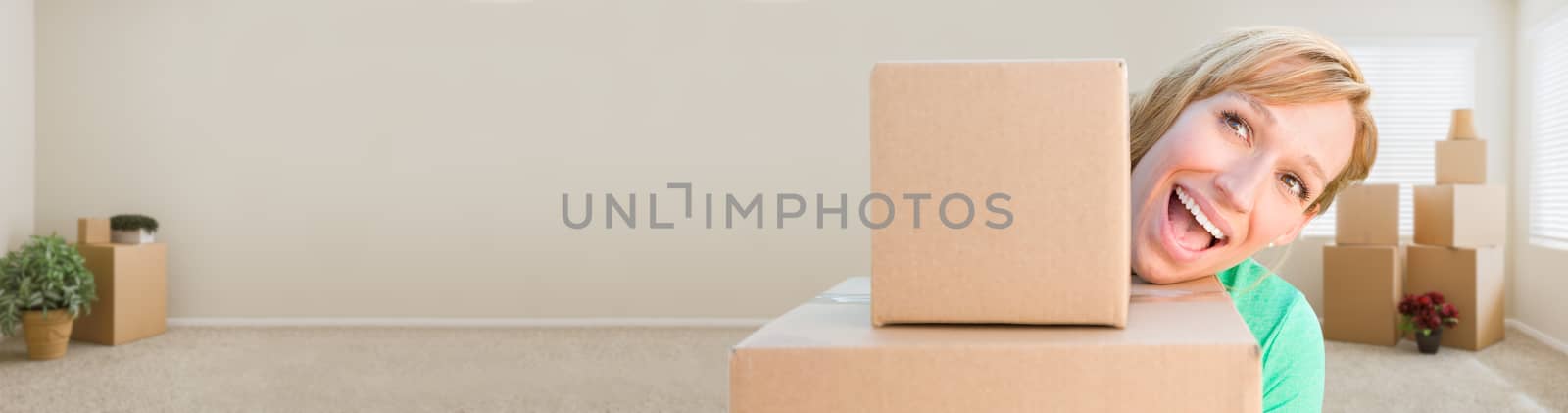 Banner of Happy Young Adult Woman Holding Moving Boxes In Empty Room In A New House.