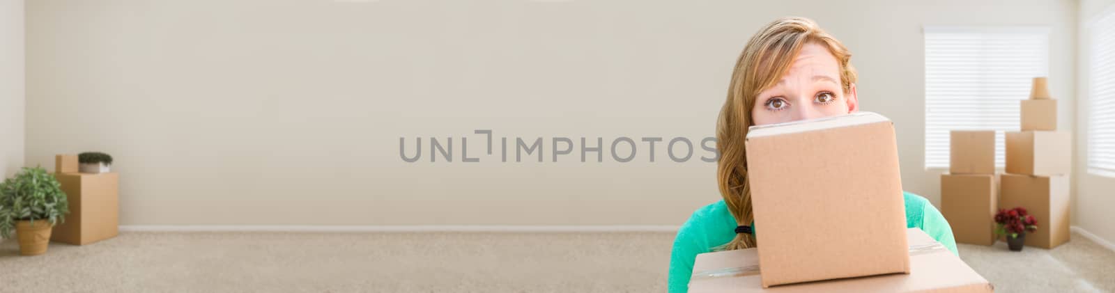 Banner of Happy Young Adult Woman Holding Moving Boxes In Empty Room In A New House.