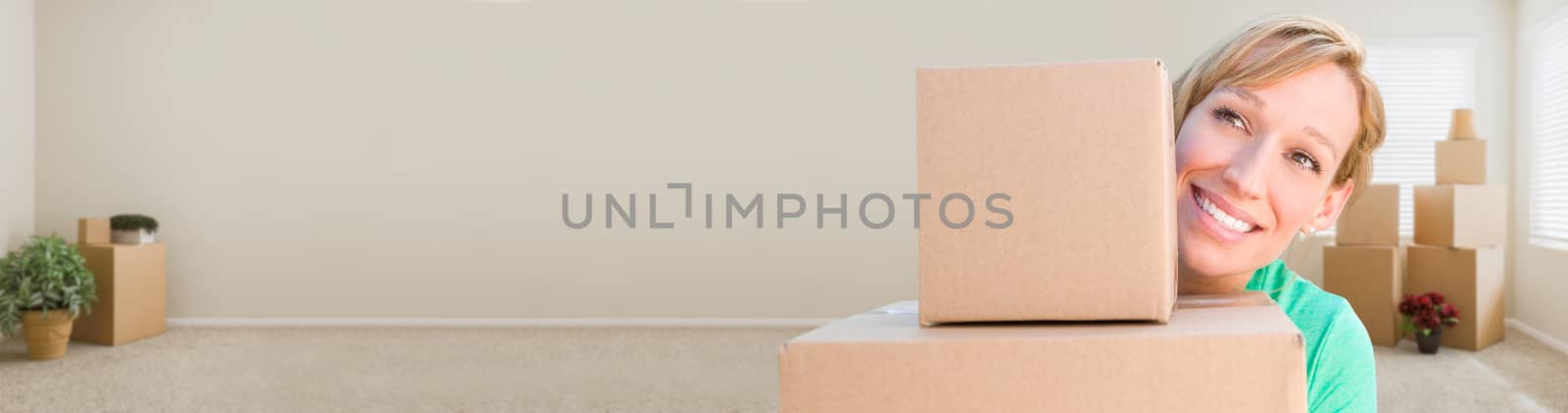 Banner of Happy Young Adult Woman Holding Moving Boxes In Empty Room In A New House.