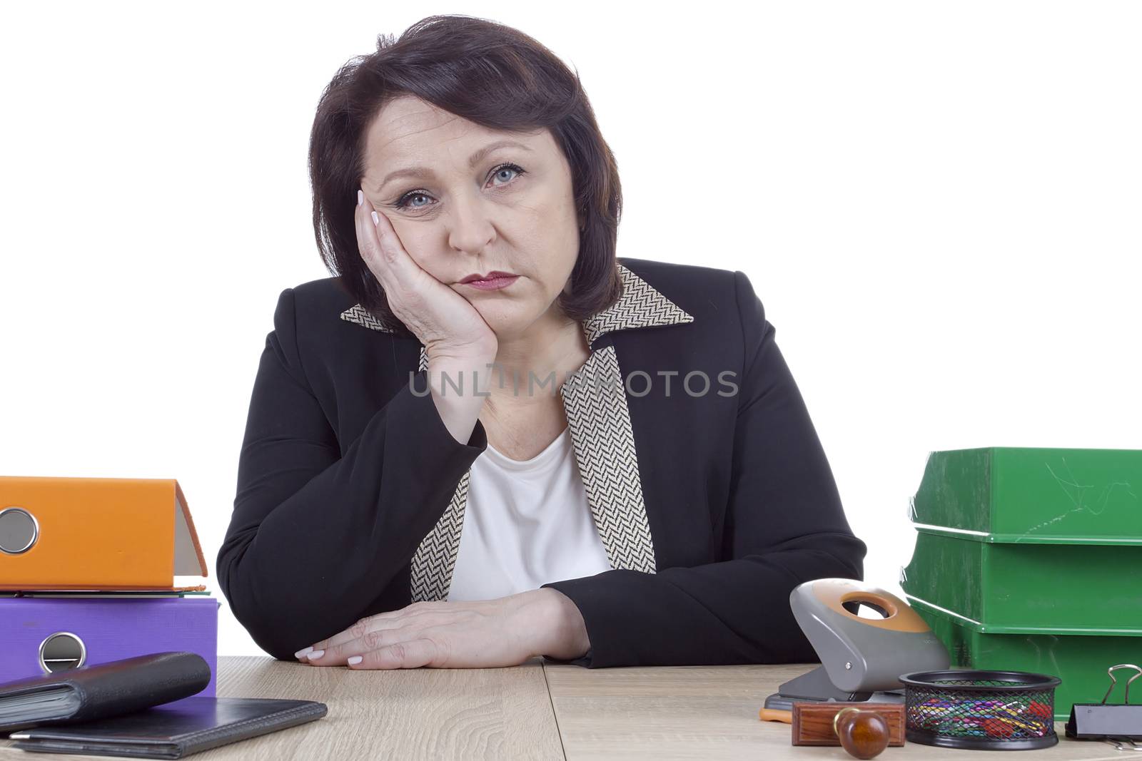 Tired sad business woman at work table