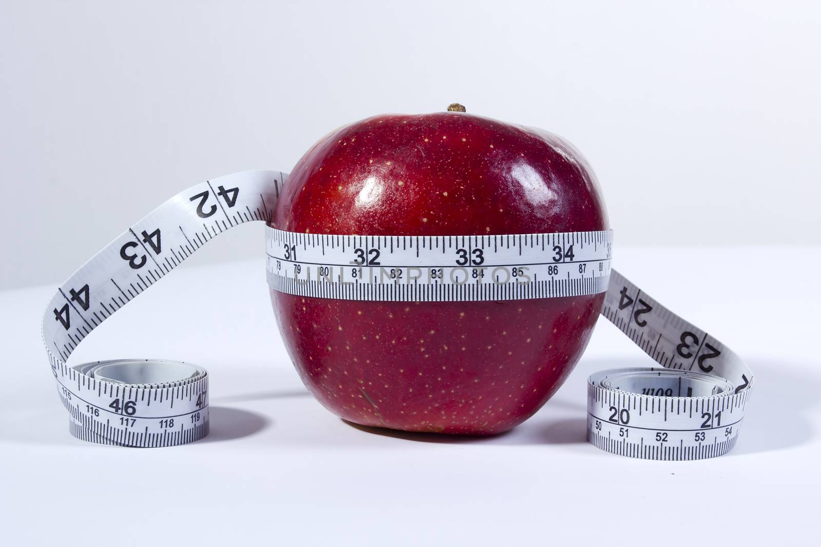 Concept of tape measure and apple. by VIPDesignUSA