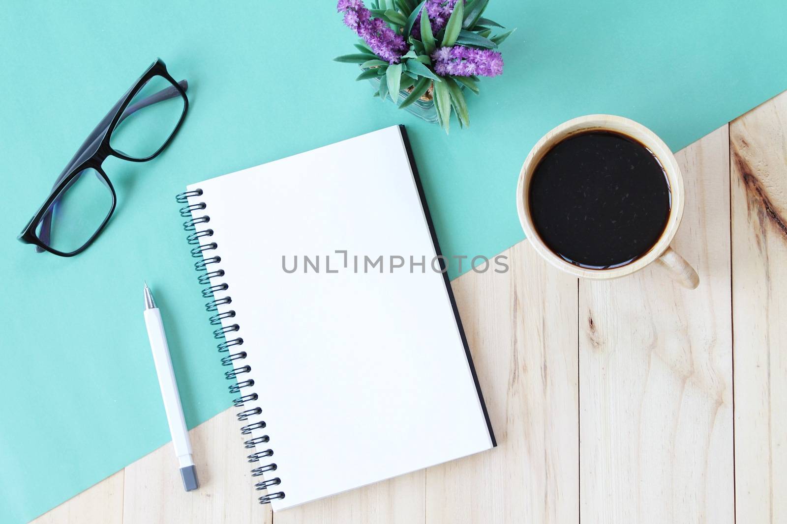 Still life, business, office supplies or education concept : Top view image of open notebook with blank pages and coffee cup on wooden background, ready for adding or mock up