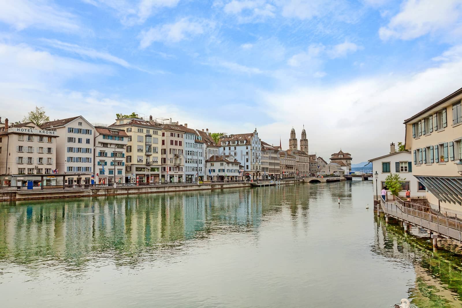 Zurich, Switzerland - June 10, 2017: Downtown view of Zurich from bridge Rudolf-Brun-Brucke, Grossmunster, town hall and river Limmat in front.