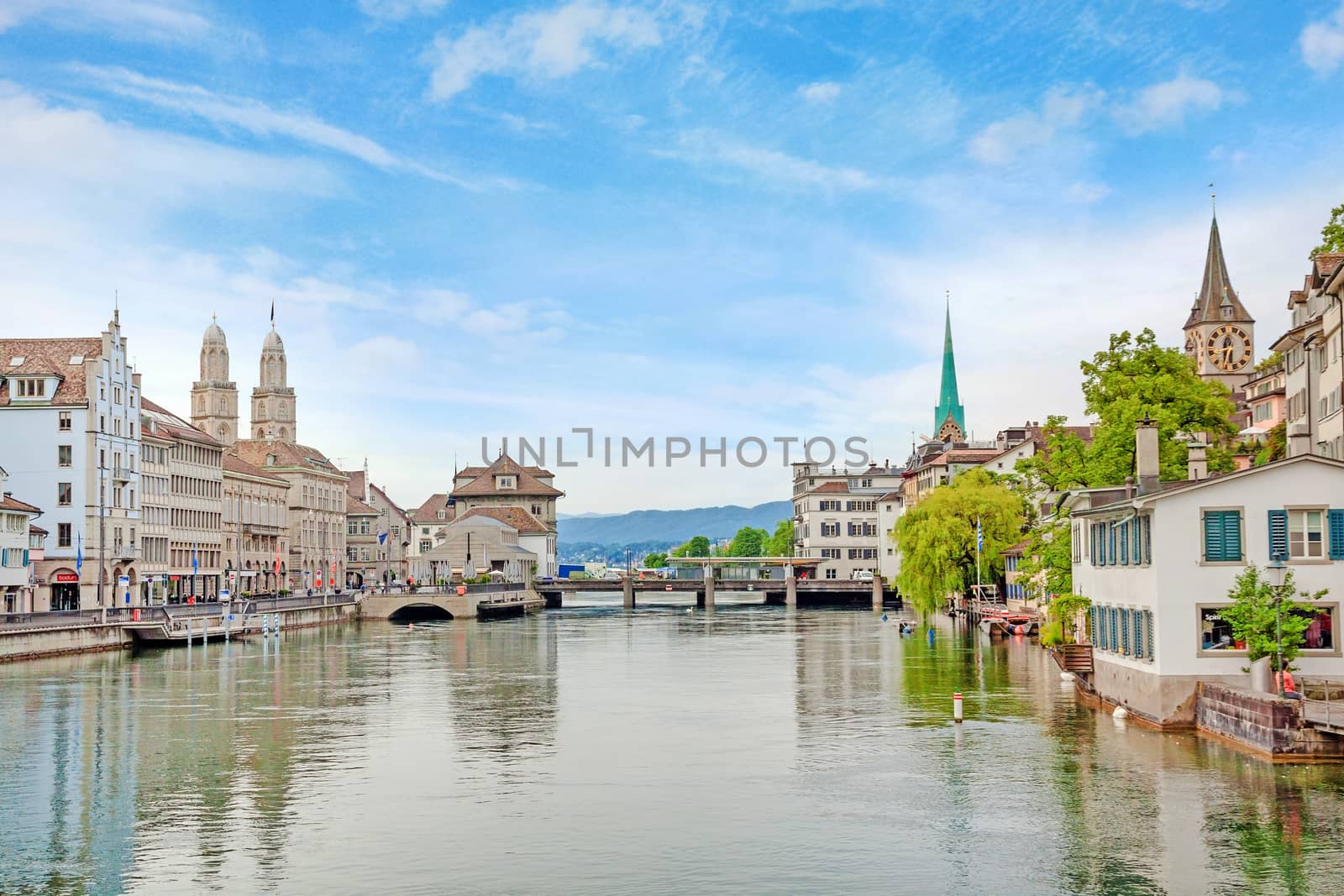 Zurich, Switzerland - June 10, 2017: Zurich downtown, view of Grossmunster, Fraumunster and St. Peter. Limmatquai (left), river Limmat in front.