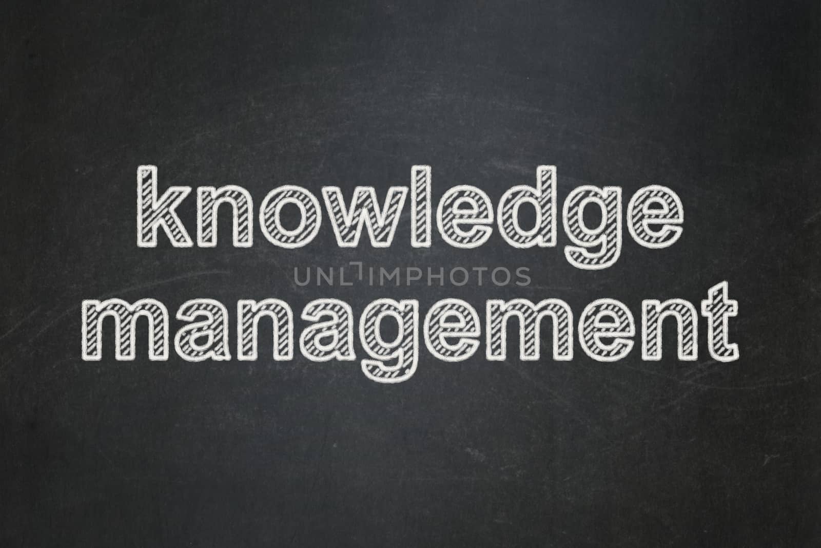 Learning concept: Knowledge Management on chalkboard background by maxkabakov