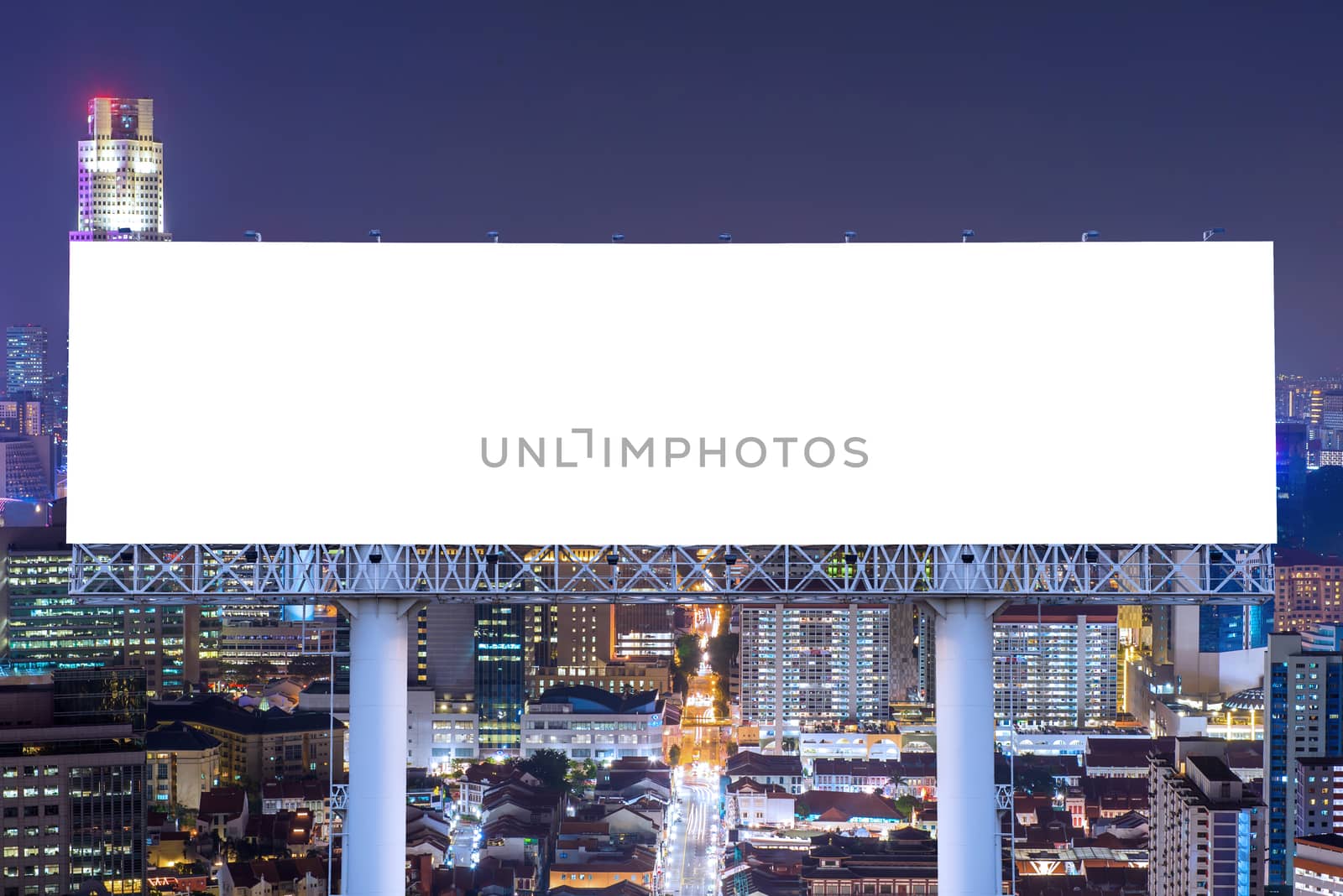 Blank billboard for advertisement in city downtown at night by casanowe