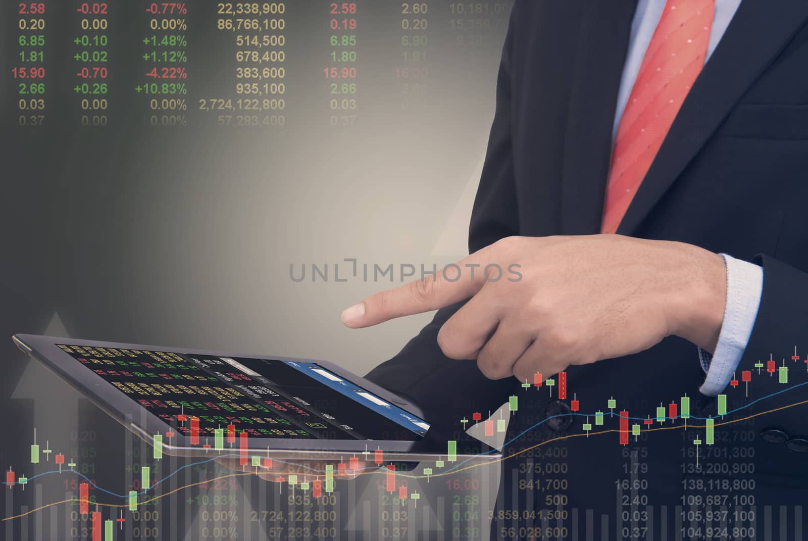 business man Trading concept using the tablet with financial graph on cityscape background, Double exposure style.
