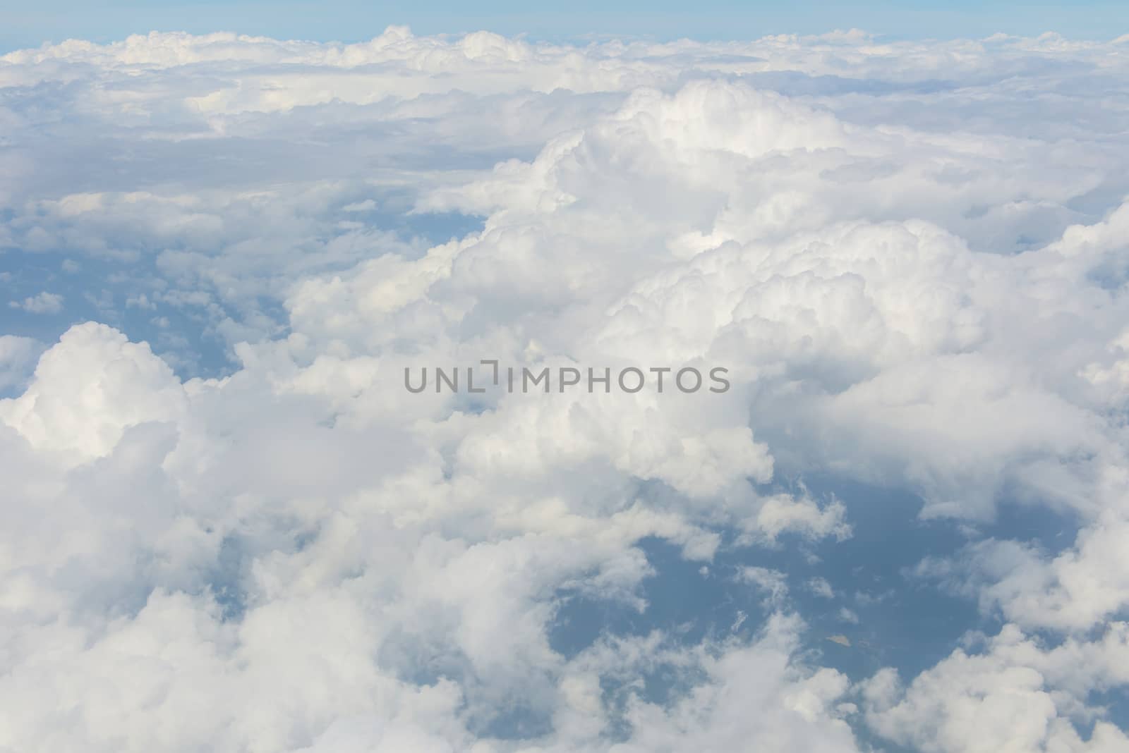 Blue sky and Clouds as seen through window of aircraft.