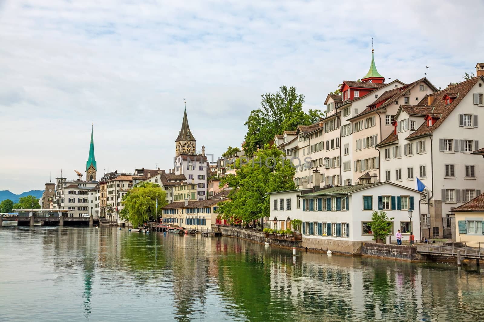 Zurich, Switzerland - June 10, 2017: Zurich downtown, with Fraumunster and St. Peter. View towards Lindenhof, Schipfe street, river Limmat in front.