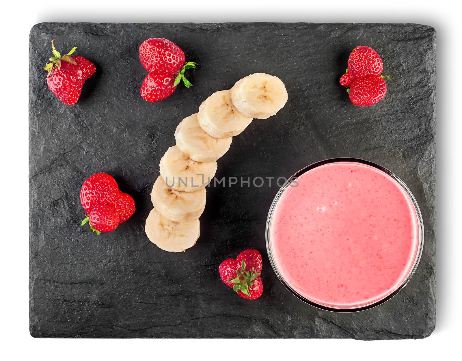 Banana strawberry smoothies with ingredients on black shale stone top view