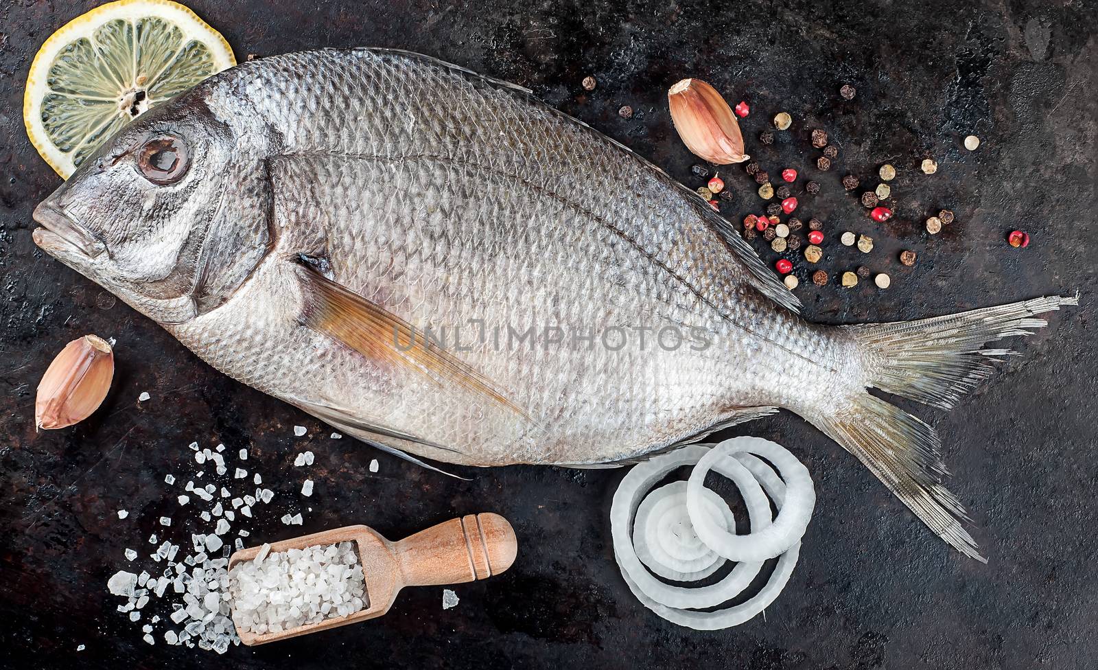 Dorado fish on pan with spices by Cipariss