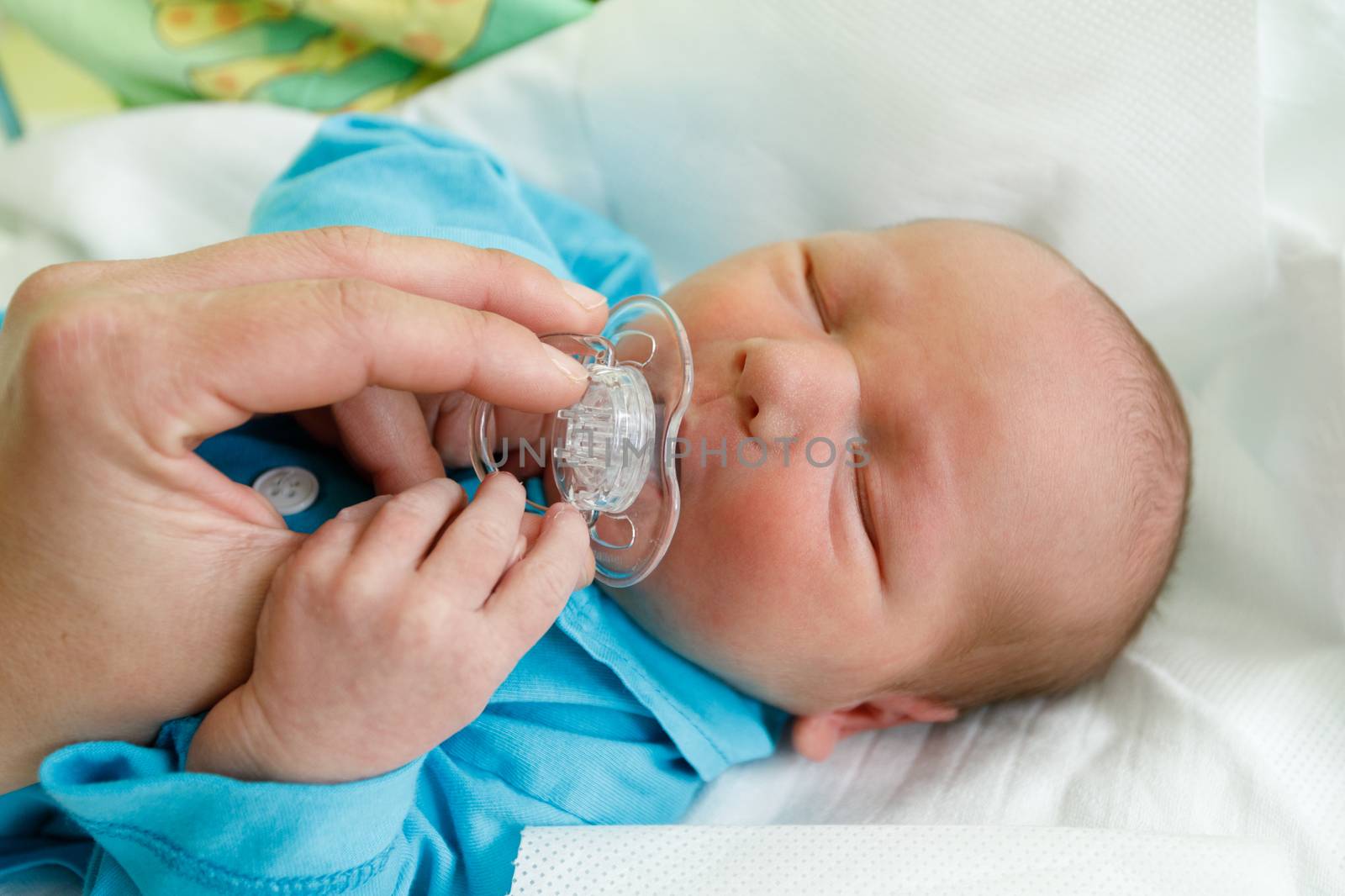 newborn baby infant in the hospital, the first hours of the new life, one days after birth