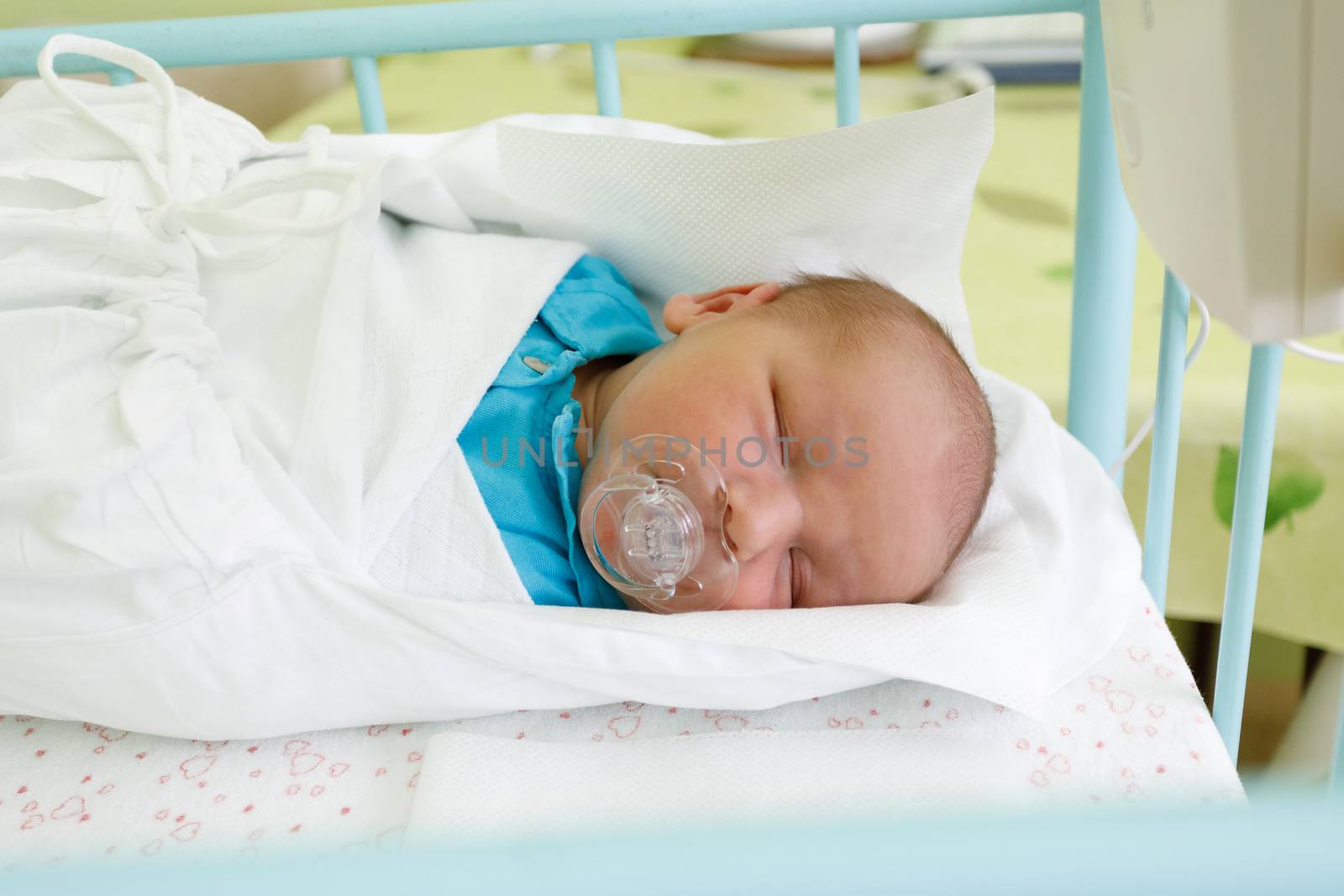 newborn baby infant in the hospital, the first hours of the new life, one days after birth