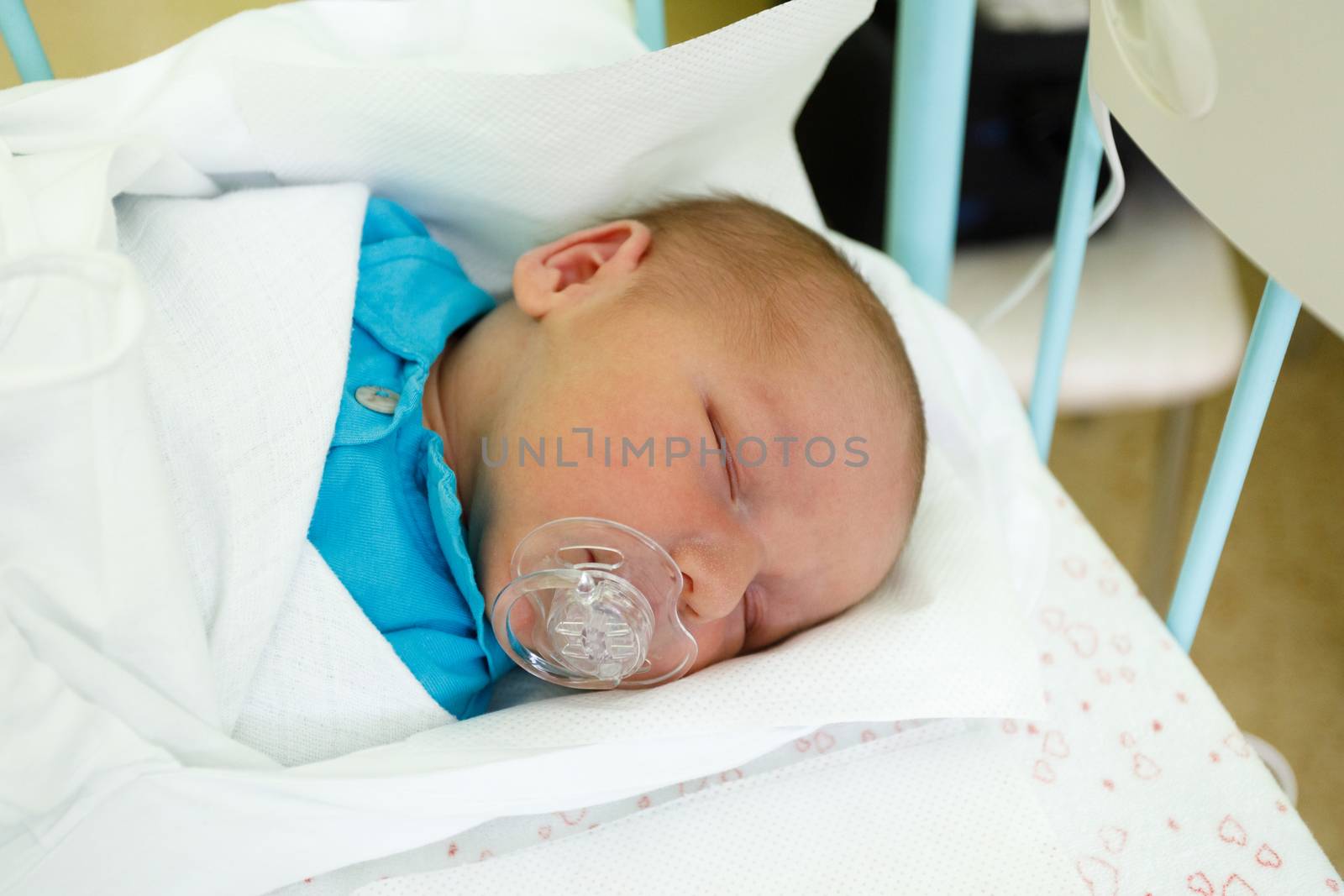 newborn baby infant in the hospital, the first hours of the new life, one days after birth