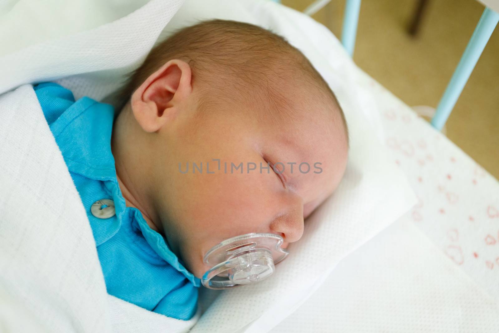 newborn baby infant in the hospital, the first hours of the new life, one days after birth