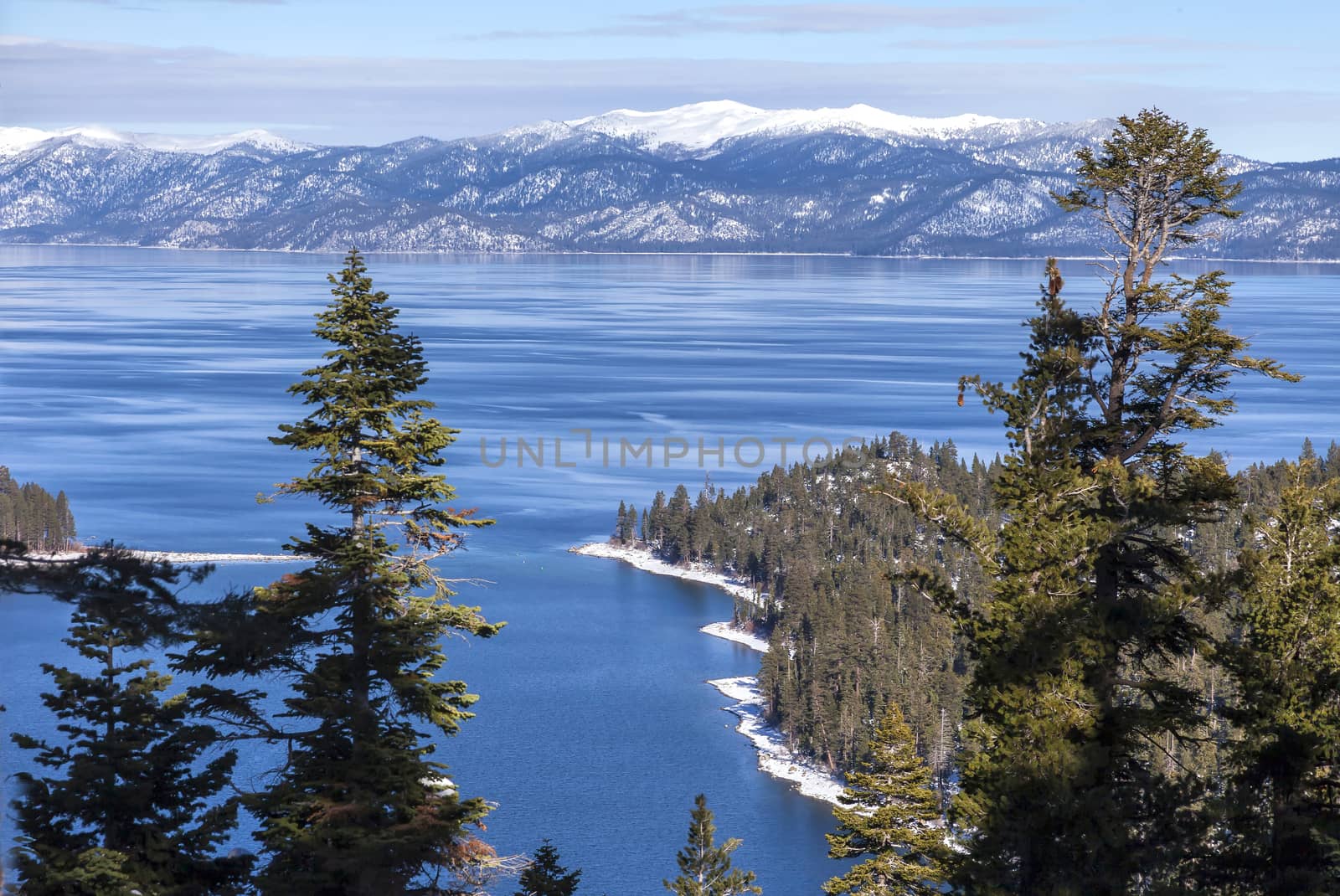 This is a winter image taken at Emerald Bay, overlooking Southern part of Lake Tahoe. The large snow capped mountain in the distance is Genoa peak.
