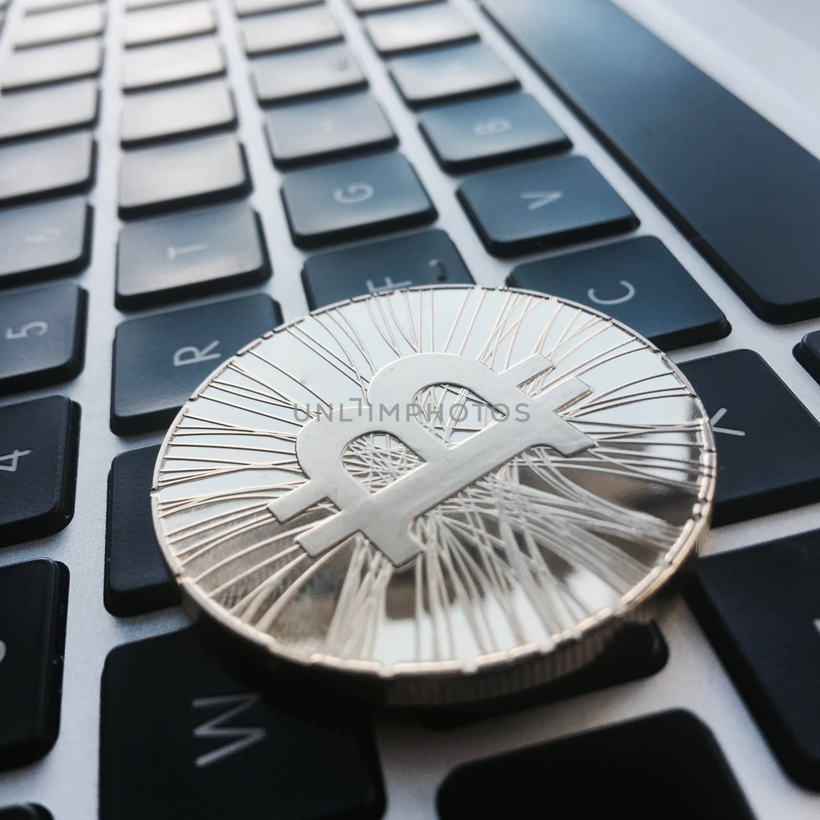 Cryptocurrency physical gold bitcoin coin on the black computer keyboard