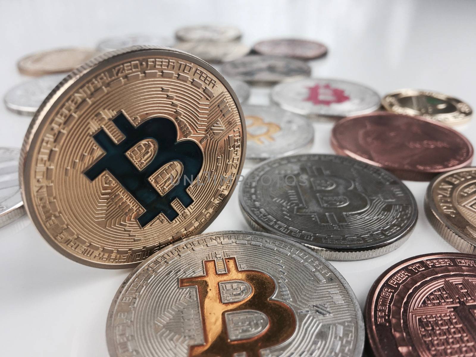 Cryptocurrency physical silver and gold bitcoin coins on the table.