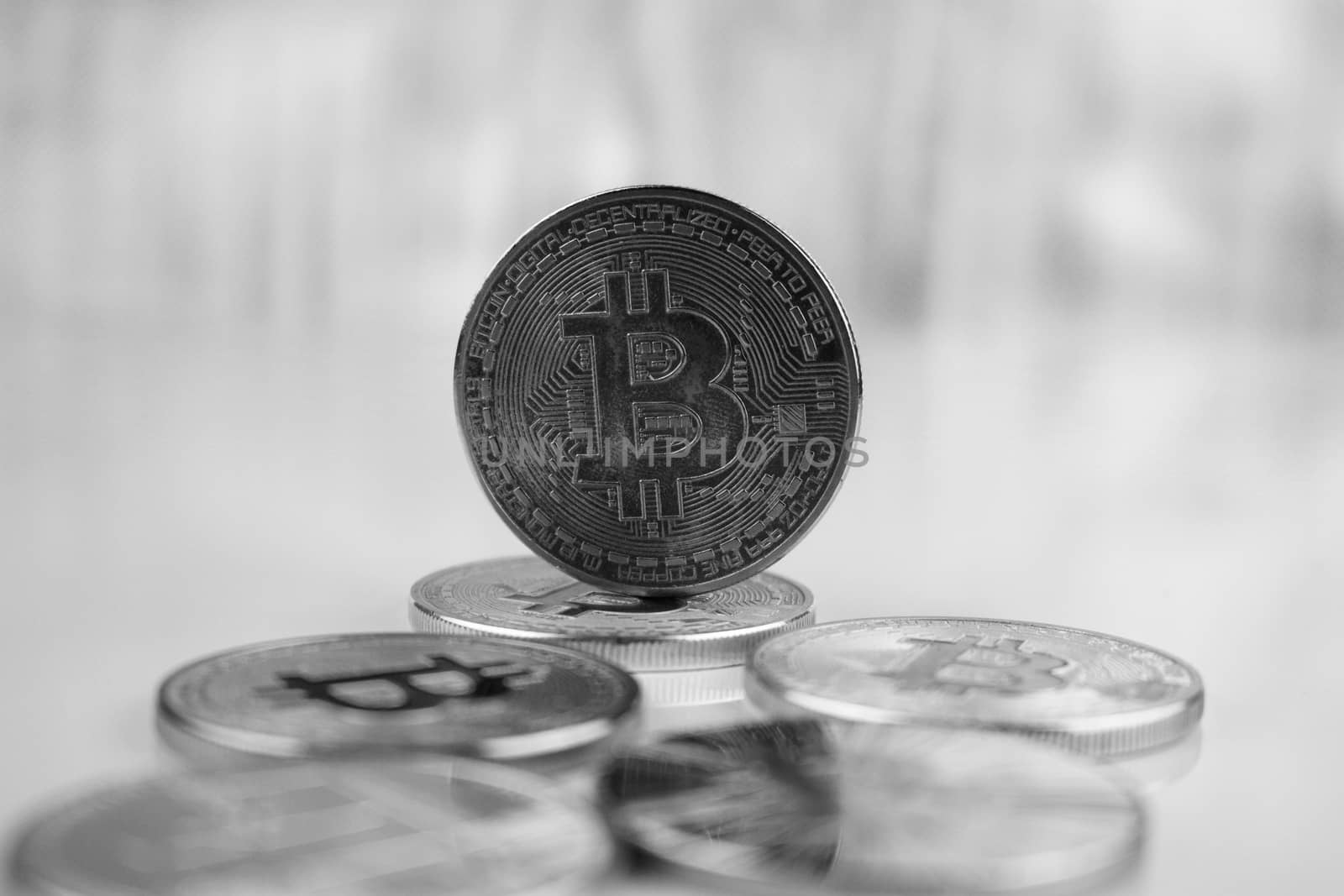 Cryptocurrency physical black bitcoin coin near other bitcoins