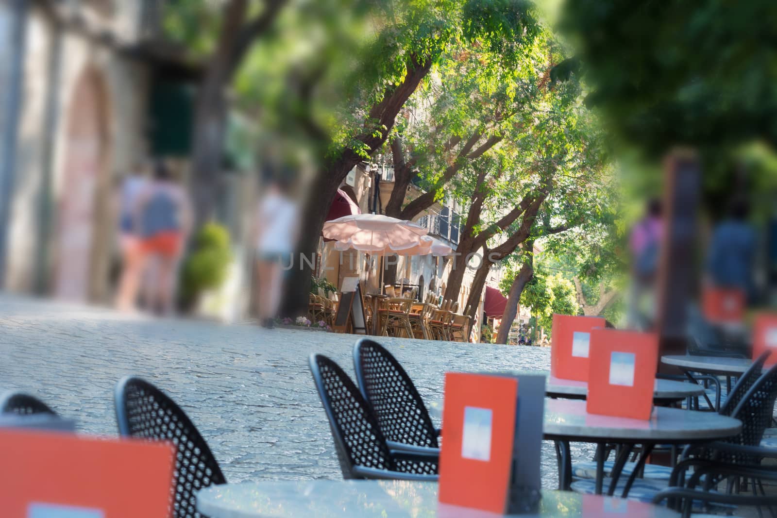 Narrow historic street with restaurant and cafes in the village of Valldemossa on Mallorca, Spain