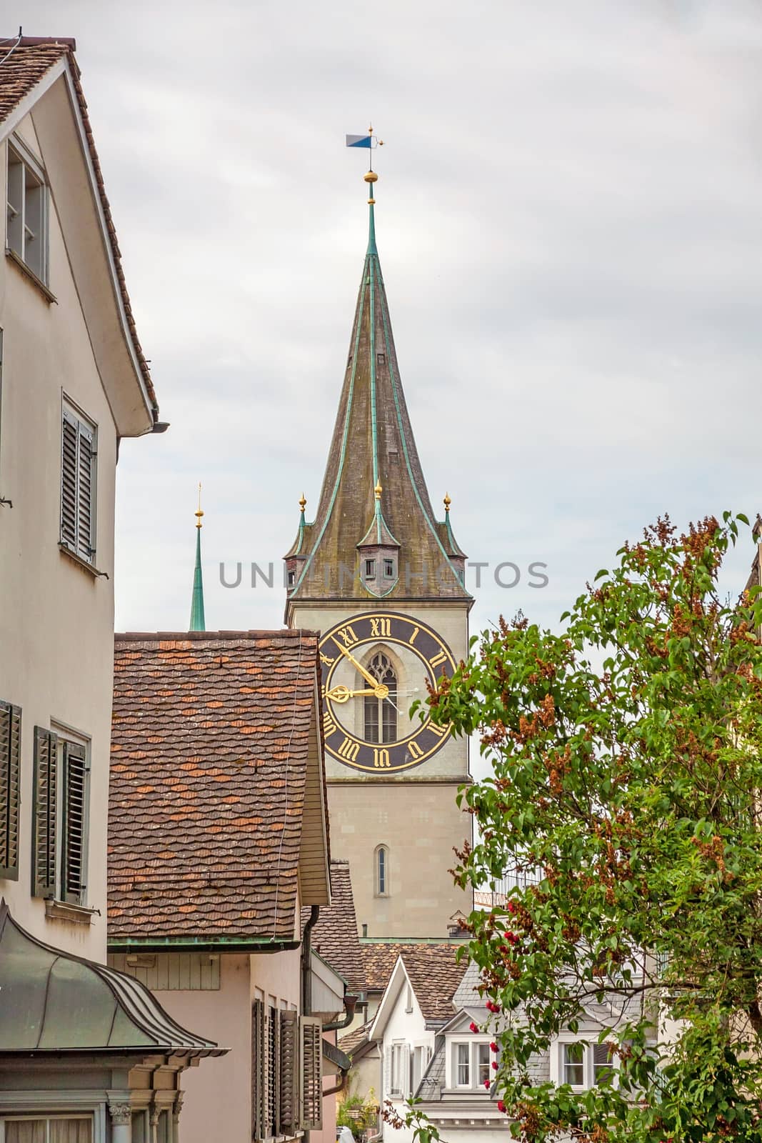 Zurich, Switzerland - June 10, 2017: Church Saint Peter, view through houses in downtown Zurich-