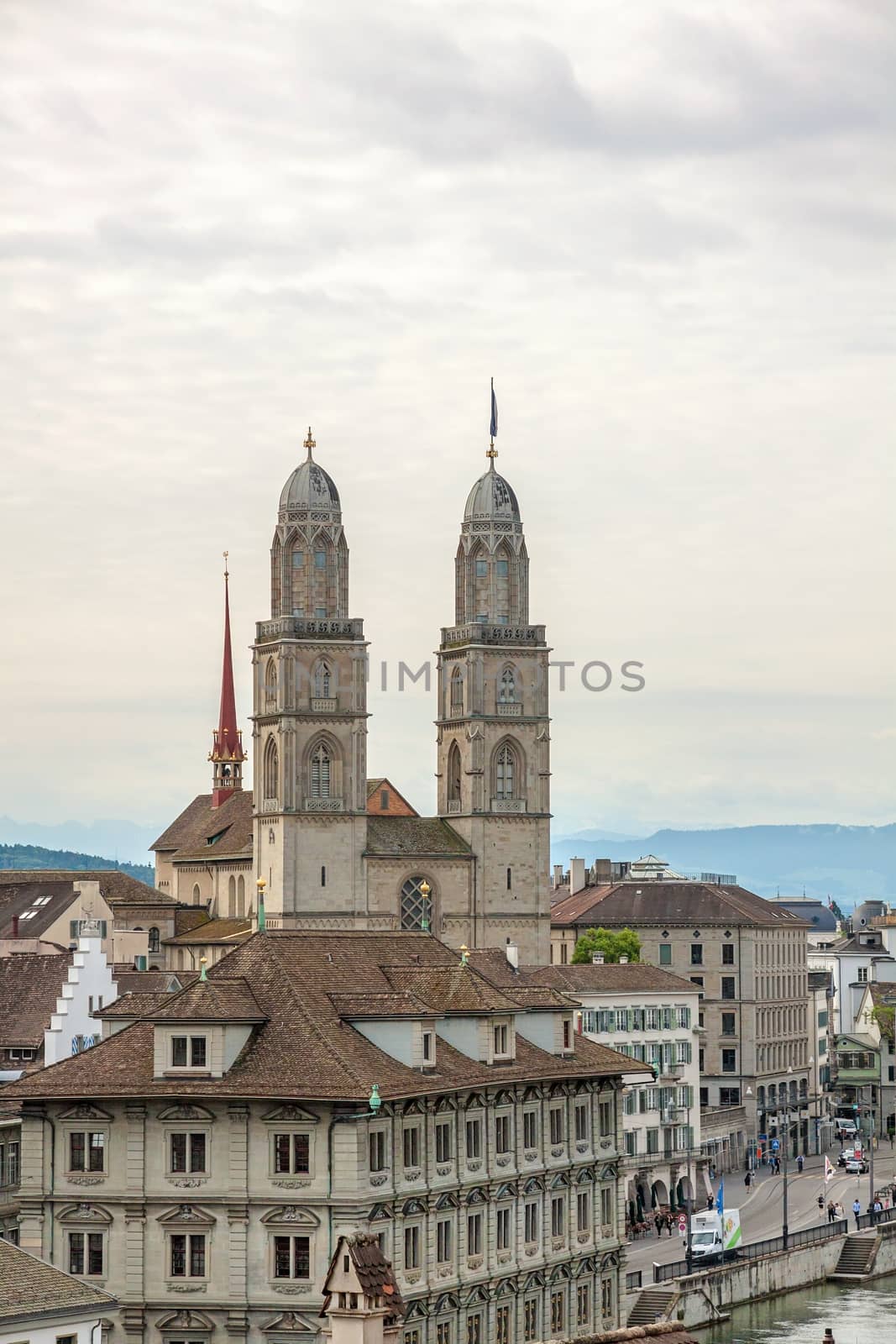 Zurich, Switzerland - June 10, 2017: The Grossmunster with town hall in front. It is a Romanesque-style Protestant church in Zurich, Switzerland. View from park Lindenhof.