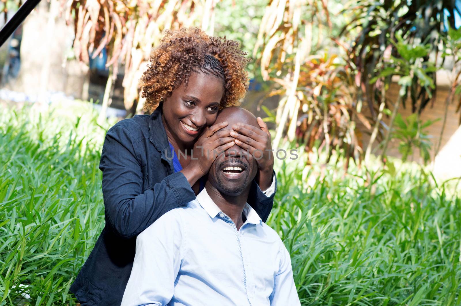 young woman played the guessing game with her lover in closing his eyes.