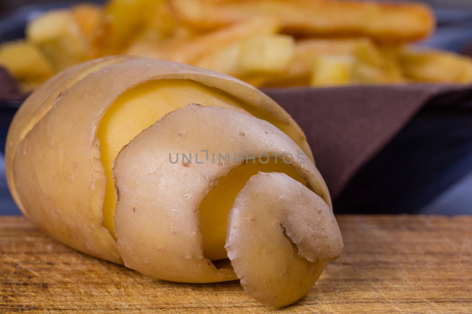 Potato peeled and cutted by hand with knife and french fries