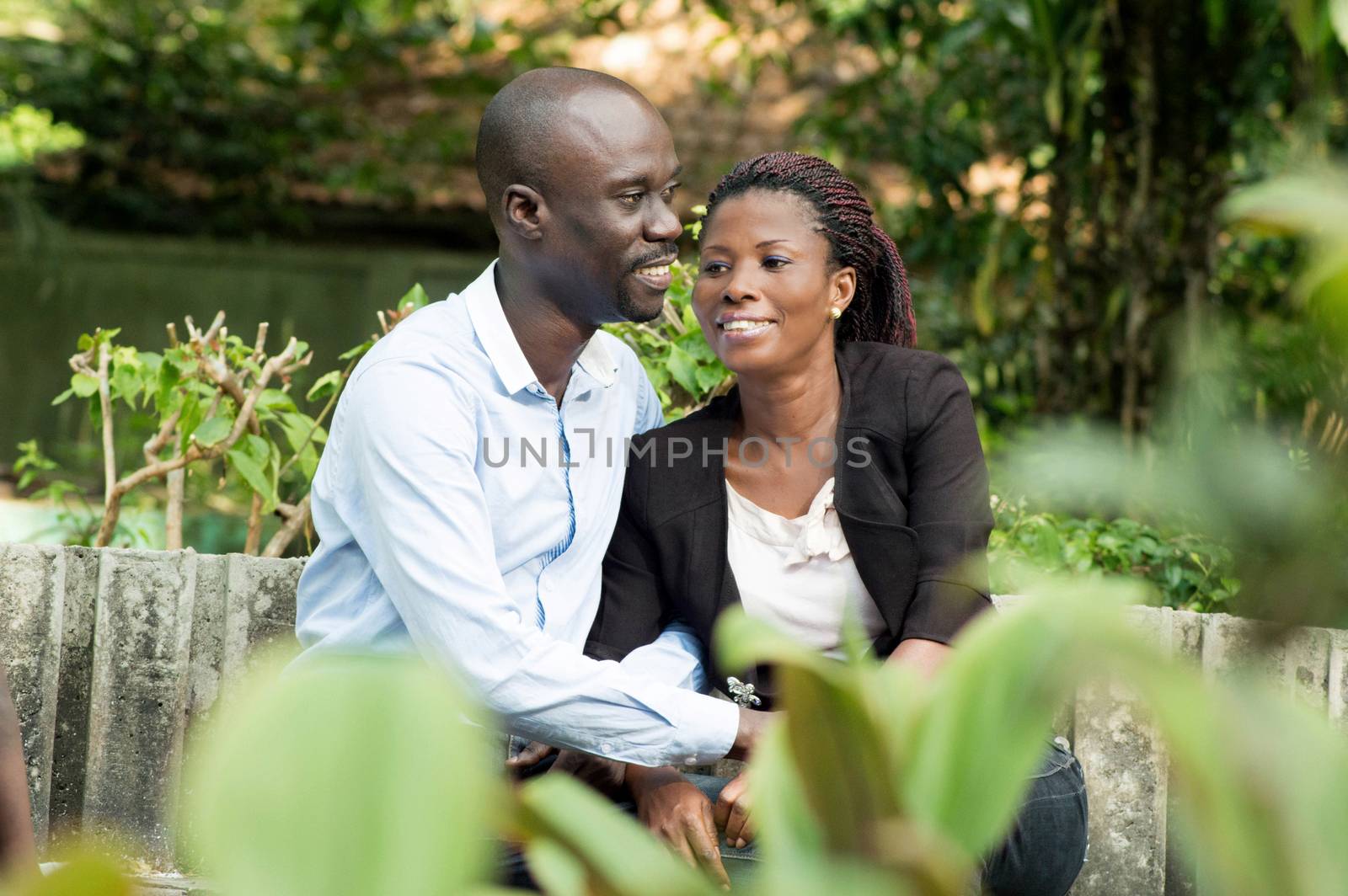 These lovers are taking air, sitting at the park.