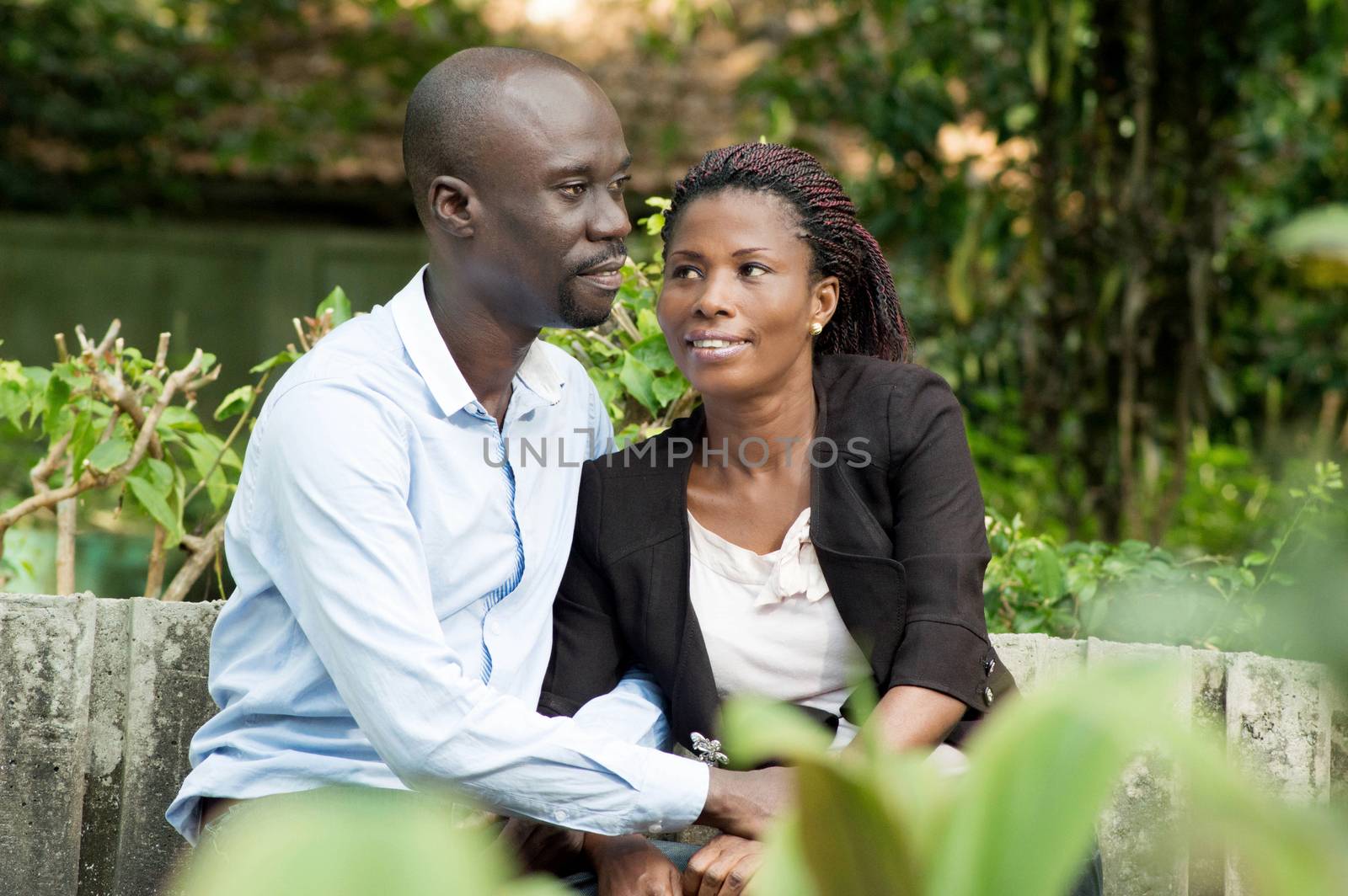 These lovers are taking air , sitting at the park.