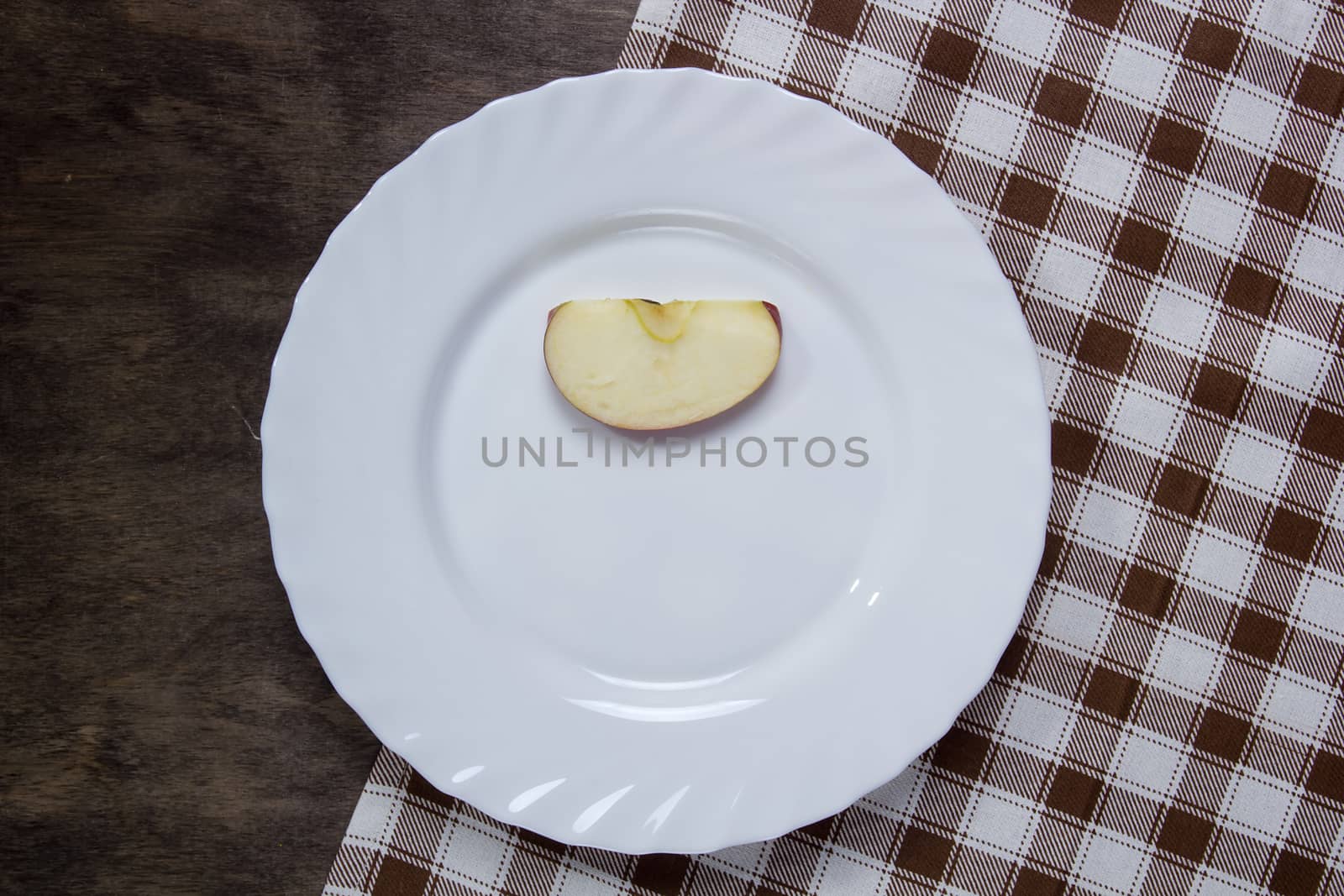 White plate with a slice of apple by VIPDesignUSA