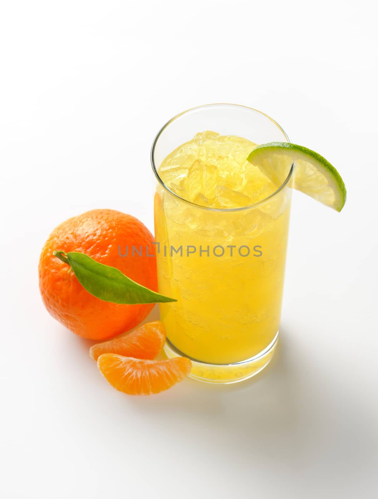 glass of mandarin juice with ice and ripe tangerine