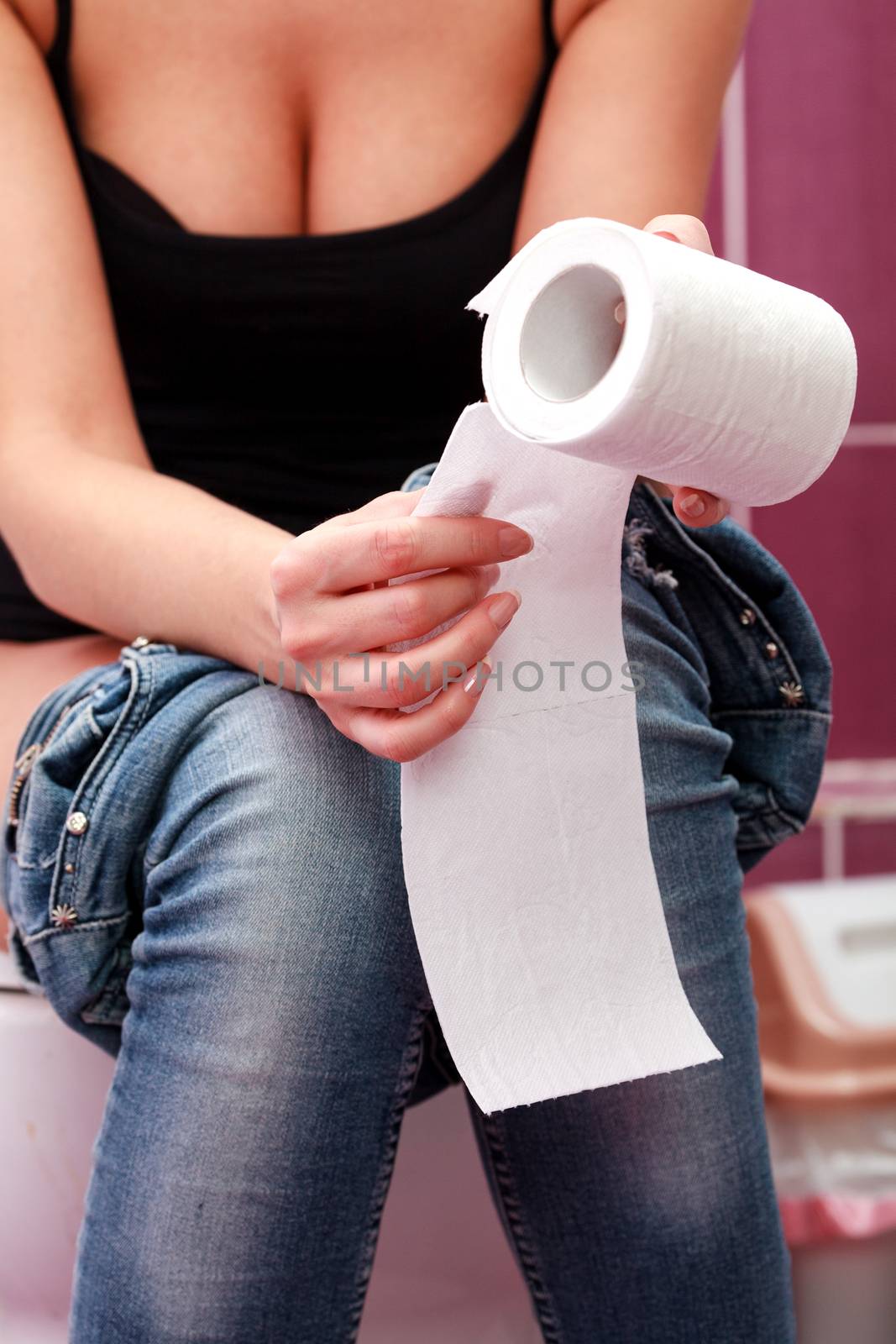 Closeup picture of a woman sitting in a toilet room by Nobilior