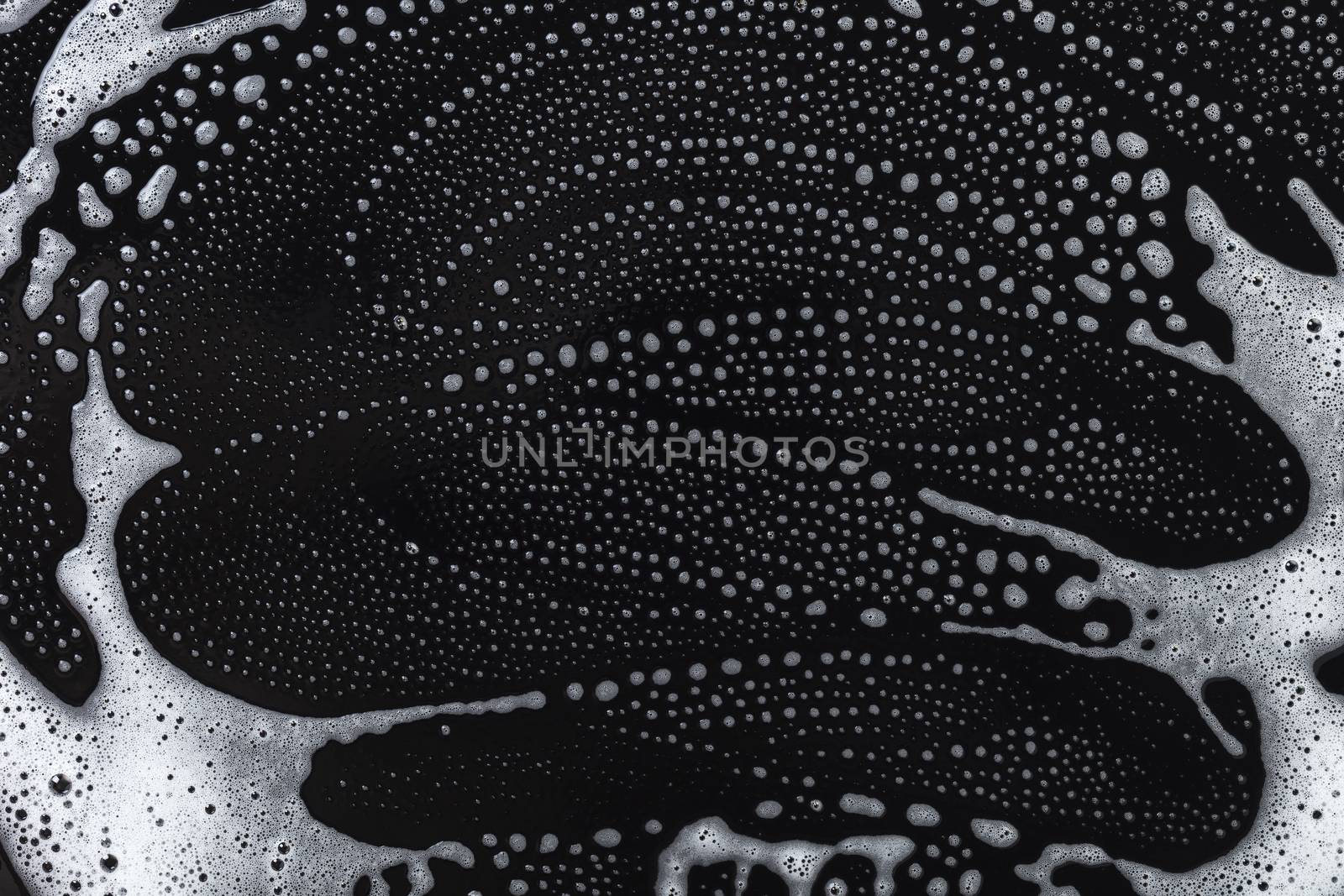 Abstract background, soapy foam texture on black