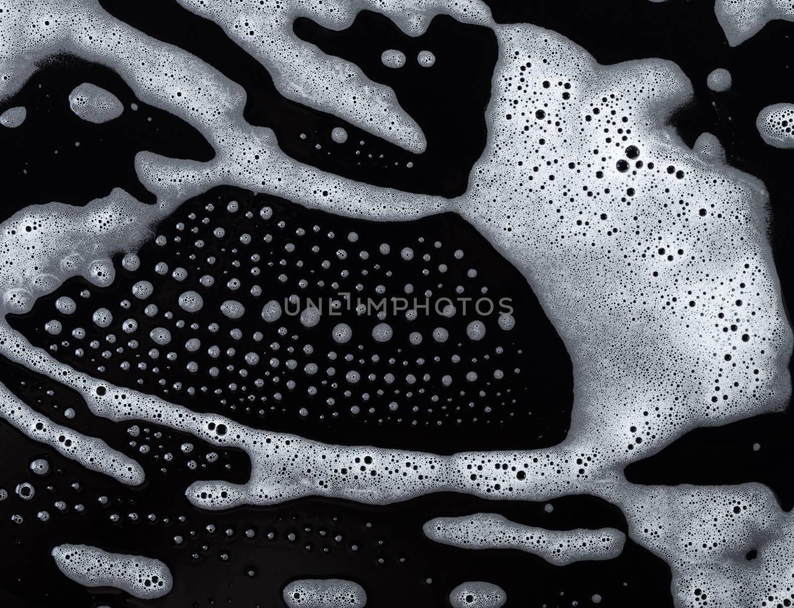 Abstract background, soapy foam texture on black