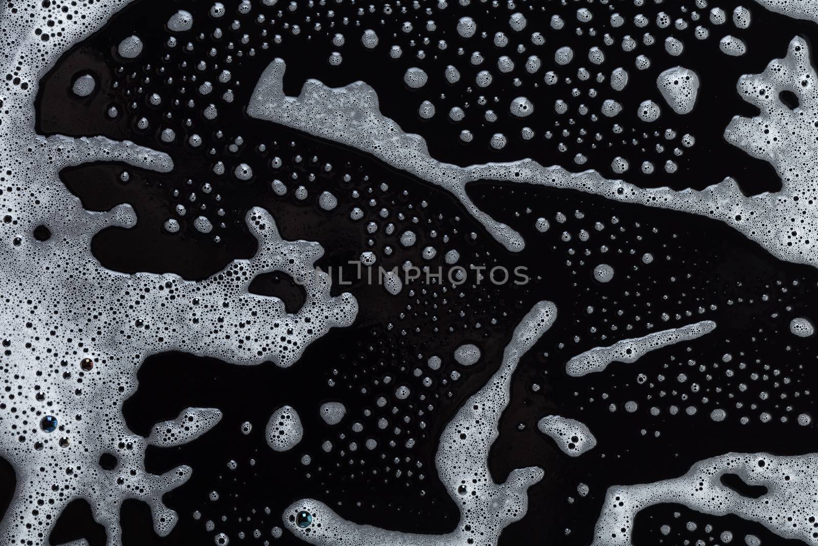 Abstract background, soapy foam texture on black