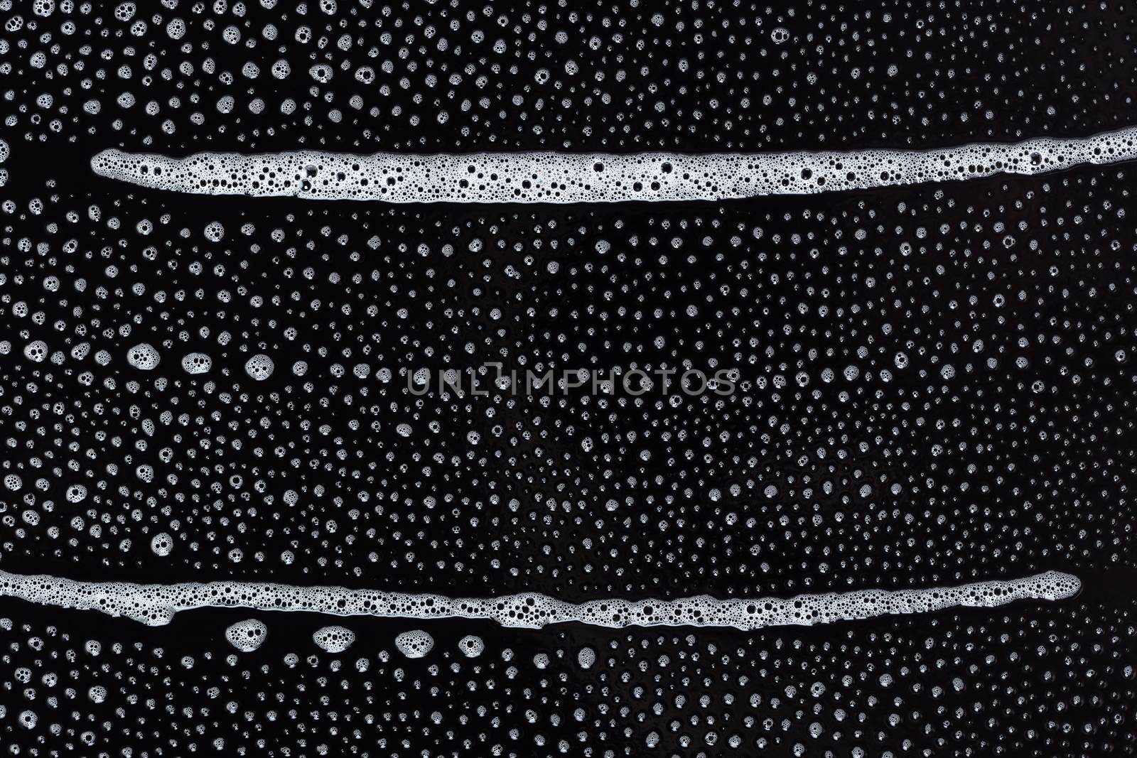 Abstract background, soapy foam texture on black
