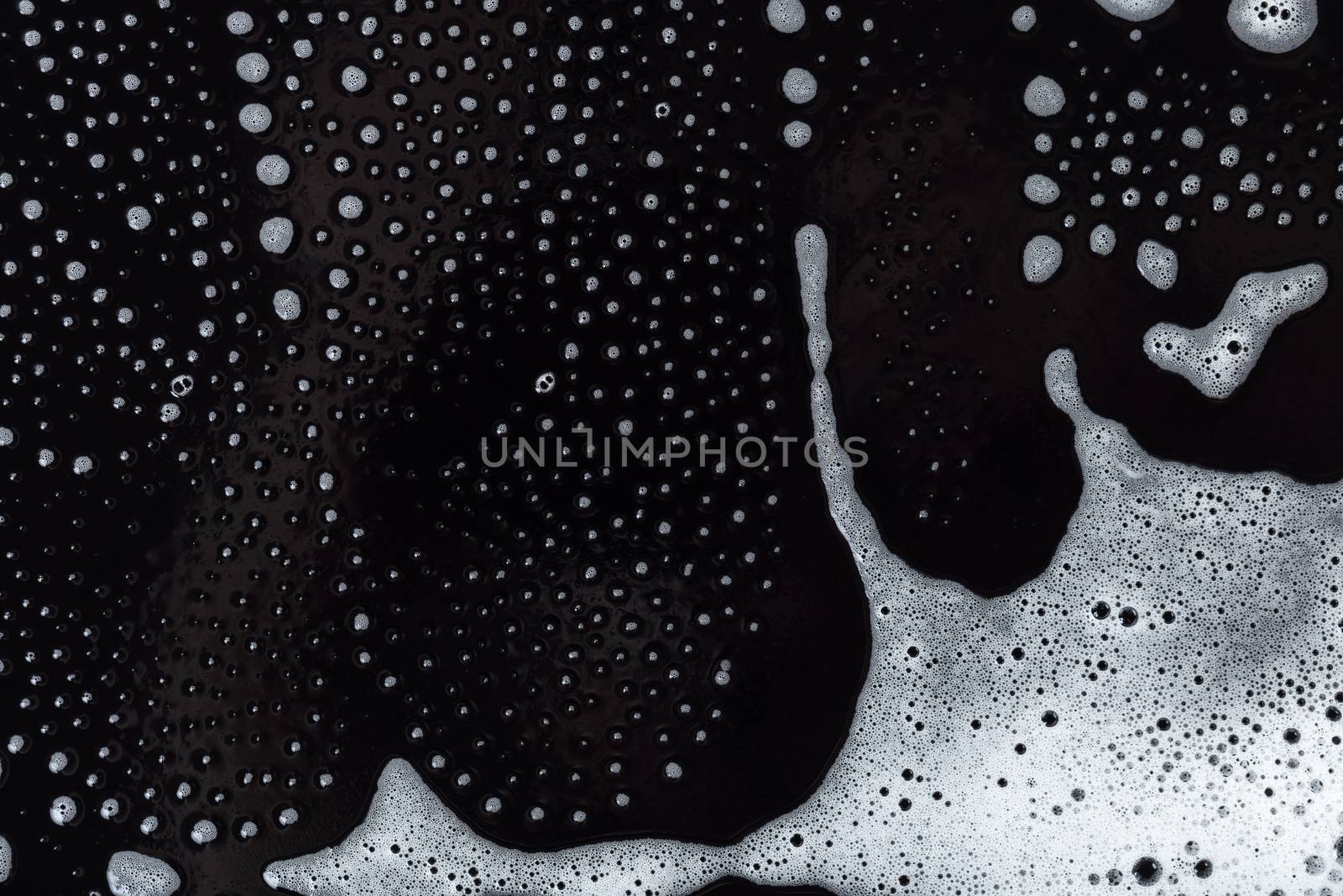 Abstract background, soapy foam texture on black