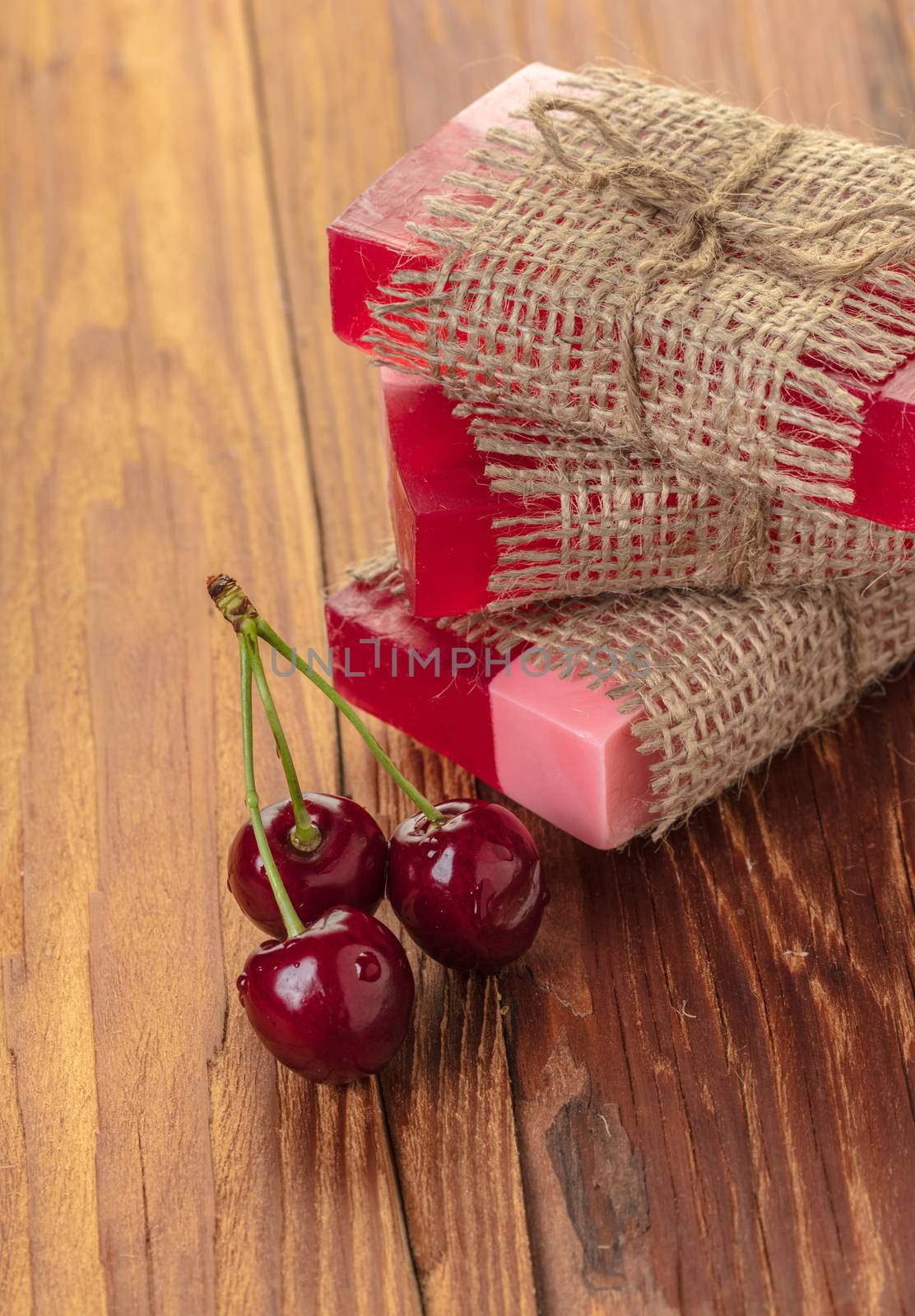 Handmade soap red cherry on a wooden background