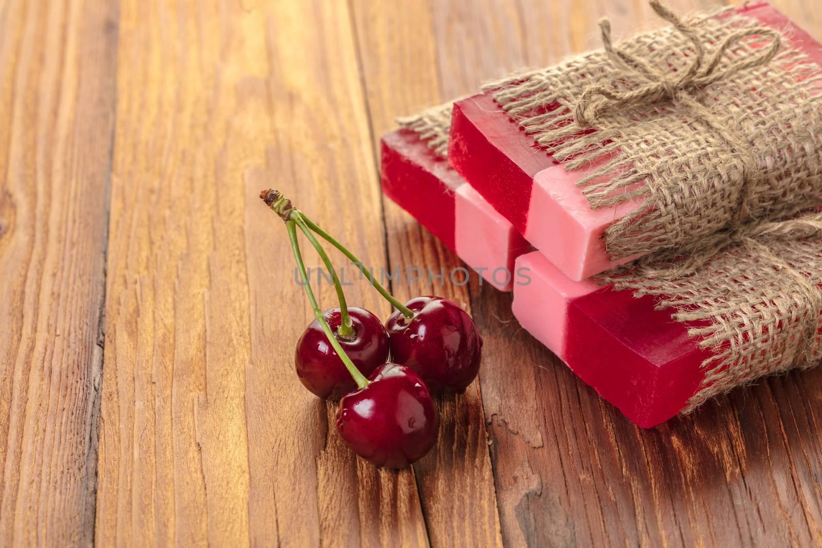 Handmade soap red cherry on a wooden background