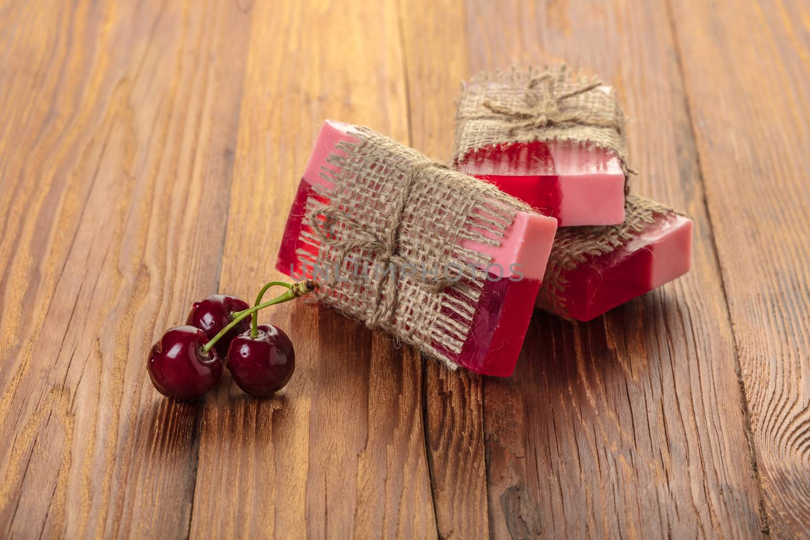 Handmade soap red cherry on a wooden background