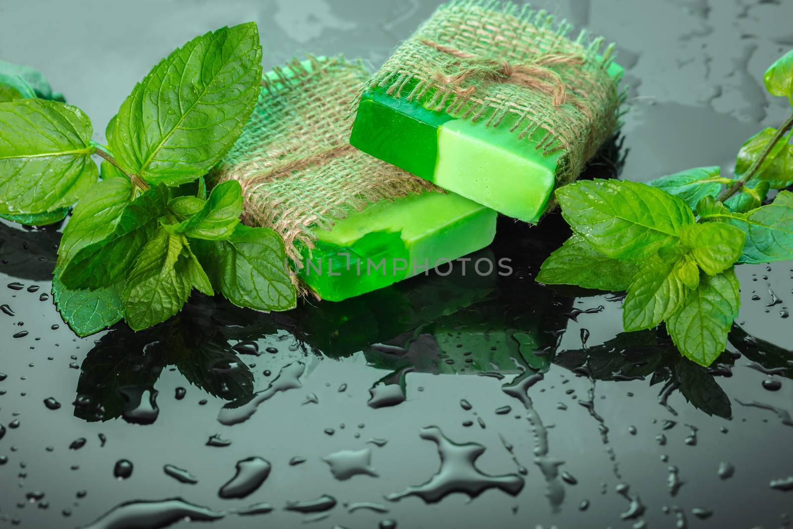 Handmade soap green with mint leaves and drops of water