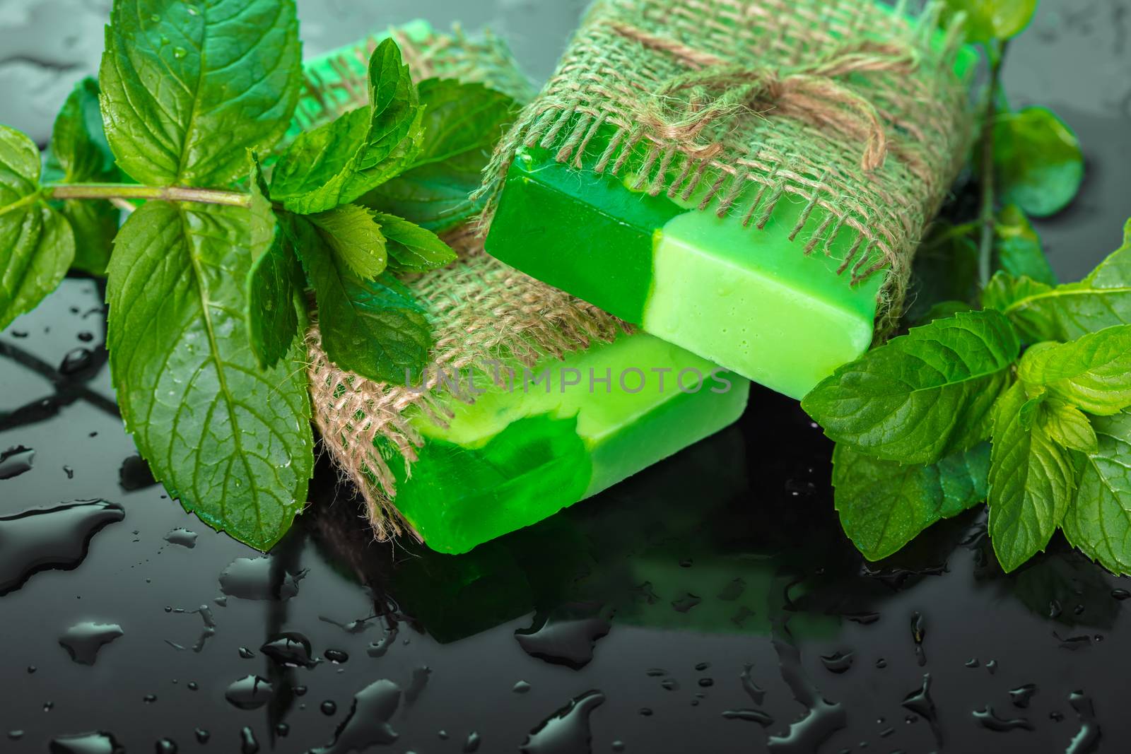 Handmade soap green with mint leaves and drops of water