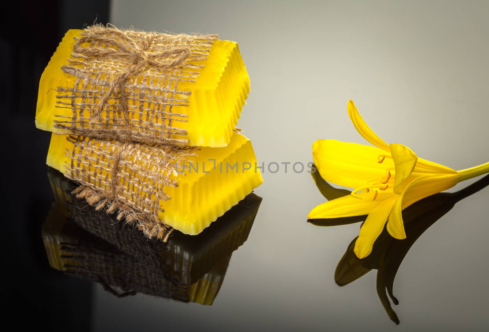 handmade soap with yellow lily on a black background