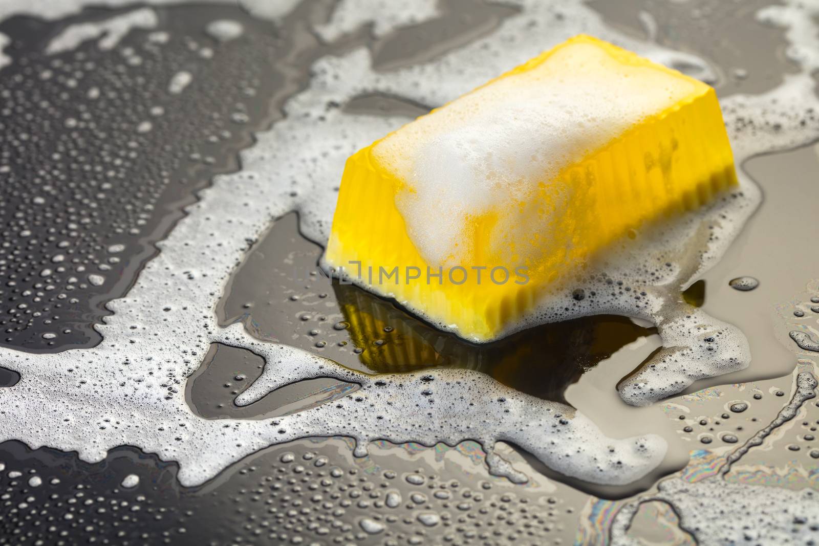 Handmade soap yellow on a black background with foam
